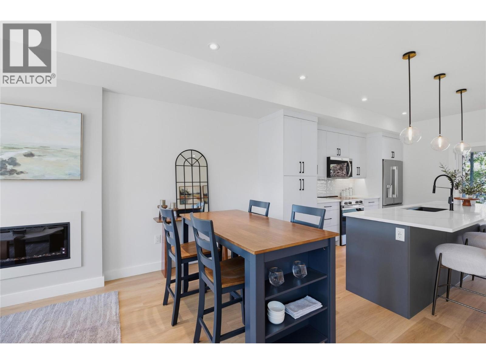 Representative listing media for Unit 101 at 143 Green Avenue, Penticton — dining area and open main level