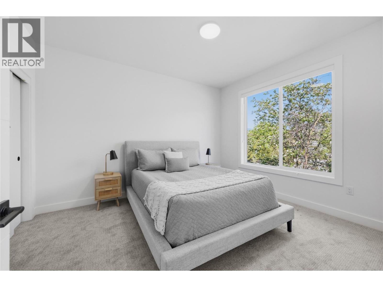 Representative listing media for Unit 101 at 143 Green Avenue, Penticton — primary bedroom