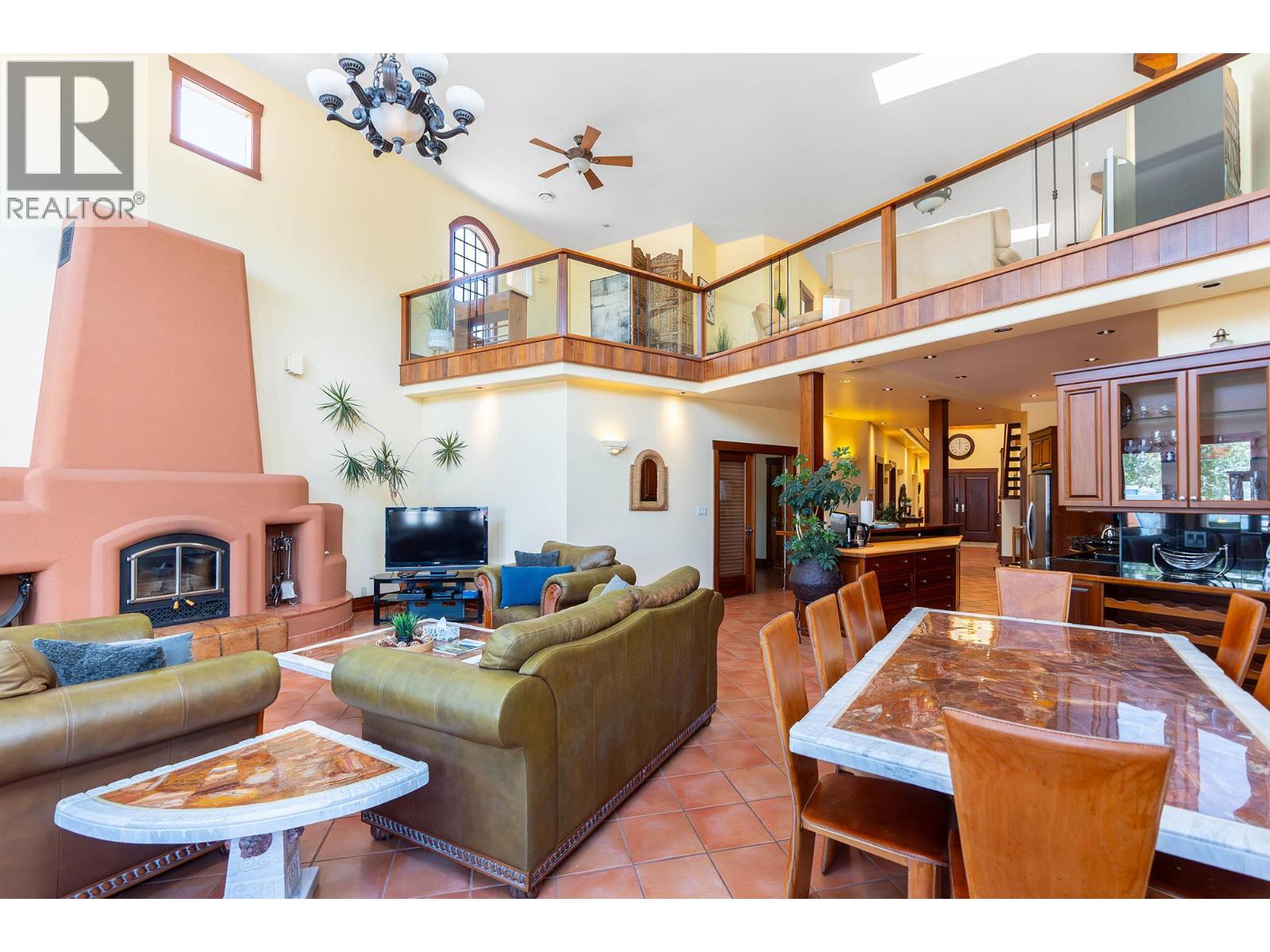 Unit 202 at Casa Grande Inn & Suites, 1070 Lakeshore Drive W, Penticton — double-height penthouse living room