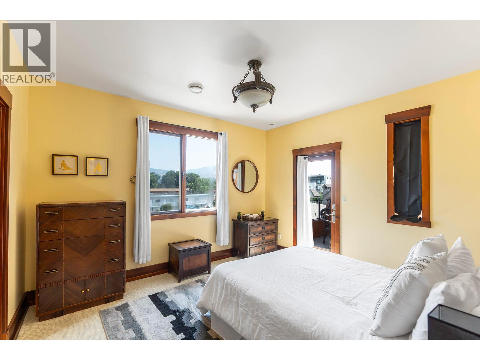 Unit 202 at Casa Grande Inn & Suites, 1070 Lakeshore Drive W, Penticton — bedroom with lake outlook