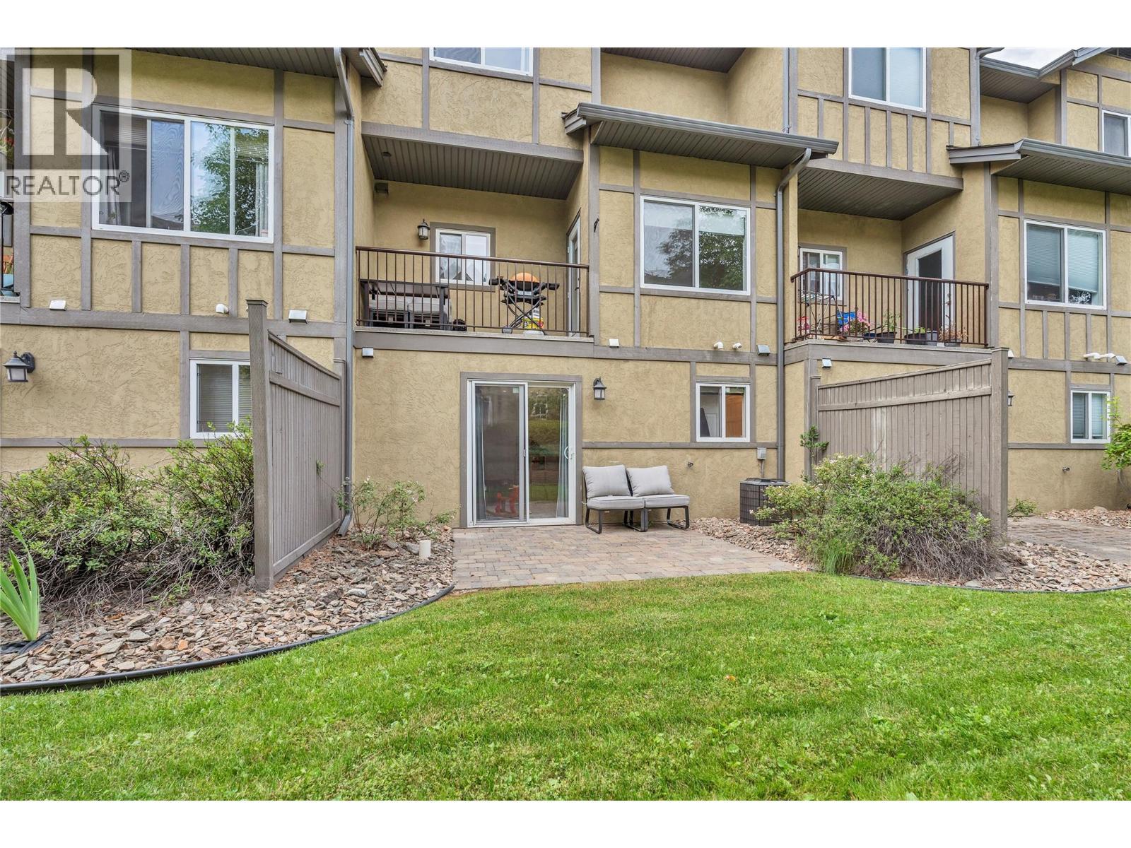Unit 116 at Somerset Court, 48 Galt Avenue, Penticton — rear exterior and lawn