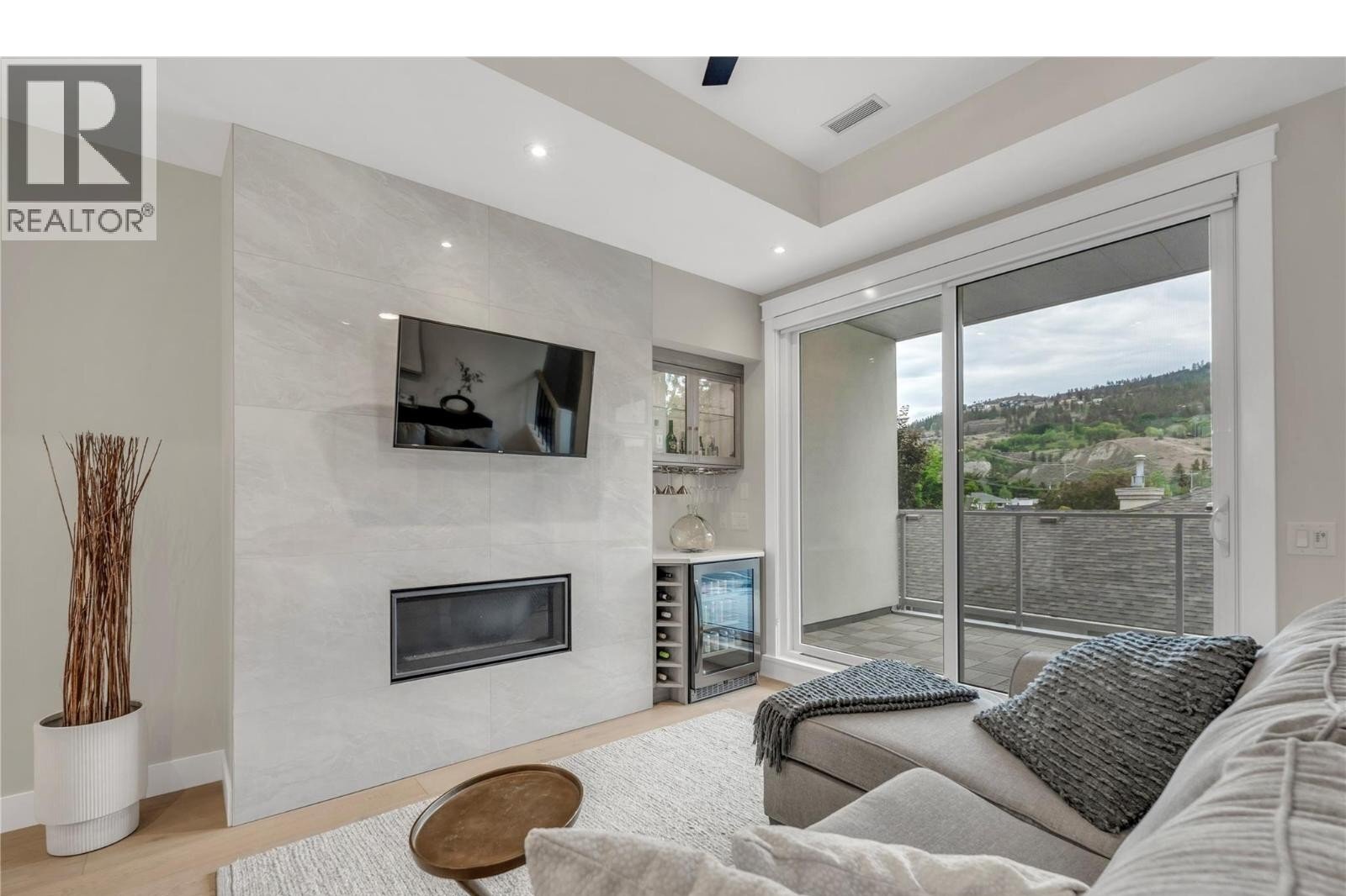 Unit 102 at The Artisan on Lee, 222 Lee Avenue, Penticton — living room with fireplace