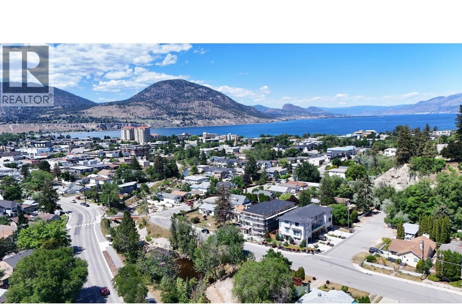 Unit 102 at The Wade Residences, 463 Wade Avenue, Penticton — aerial neighbourhood and construction view