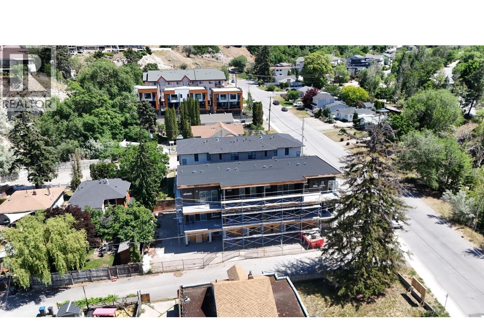 Unit 102 at The Wade Residences, 463 Wade Avenue, Penticton — aerial neighbourhood and construction view