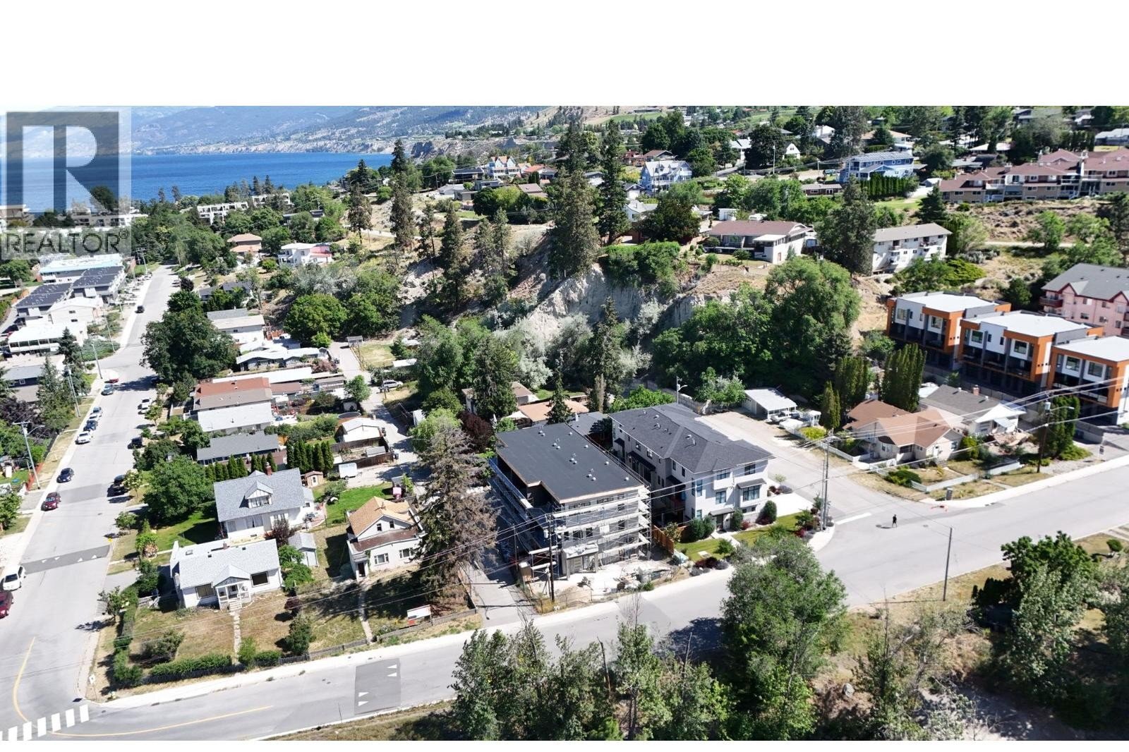 Unit 102 at The Wade Residences, 463 Wade Avenue, Penticton — aerial neighbourhood and construction view
