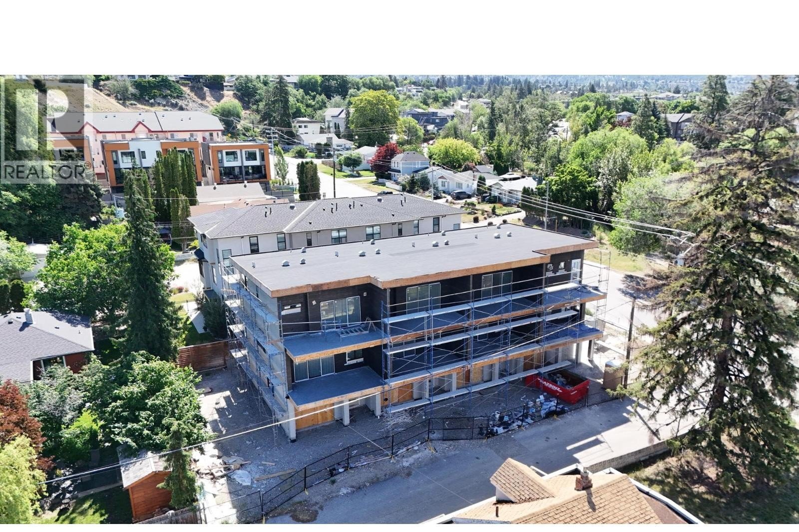 Unit 102 at The Wade Residences, 463 Wade Avenue, Penticton — aerial neighbourhood and construction view