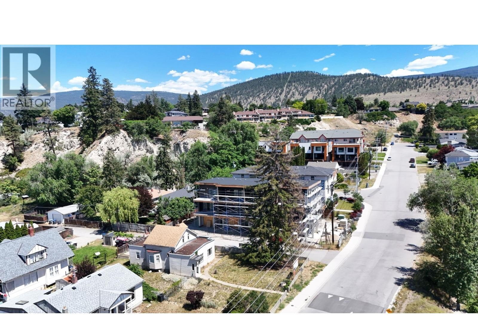 Unit 102 at The Wade Residences, 463 Wade Avenue, Penticton — aerial neighbourhood and construction view