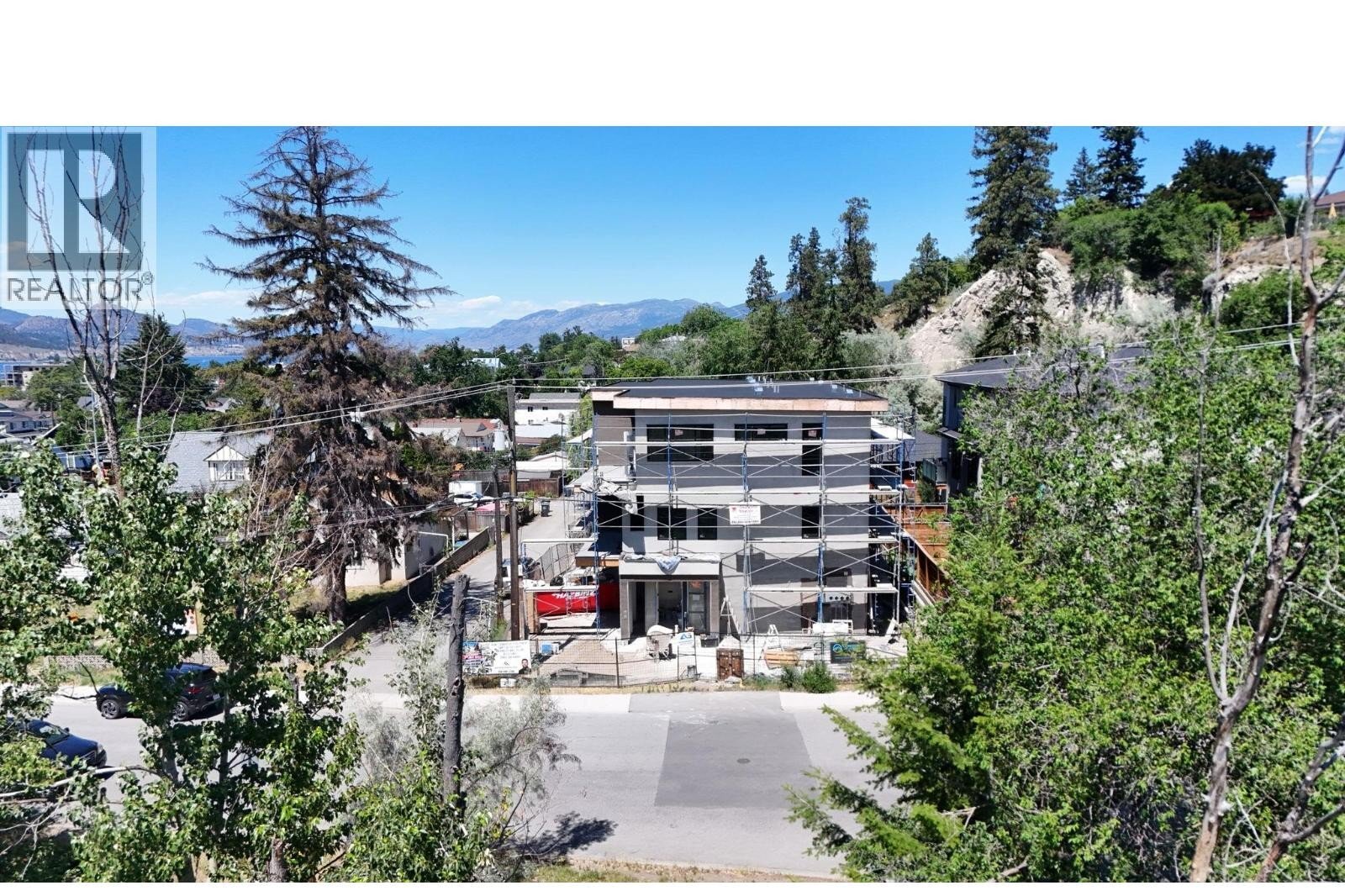 Unit 102 at The Wade Residences, 463 Wade Avenue, Penticton — aerial neighbourhood and construction view