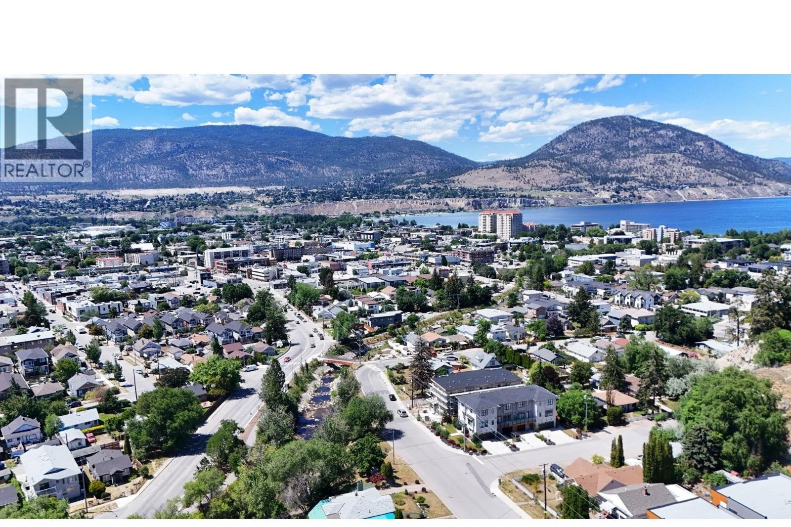 Unit 102 at The Wade Residences, 463 Wade Avenue, Penticton — aerial neighbourhood and construction view