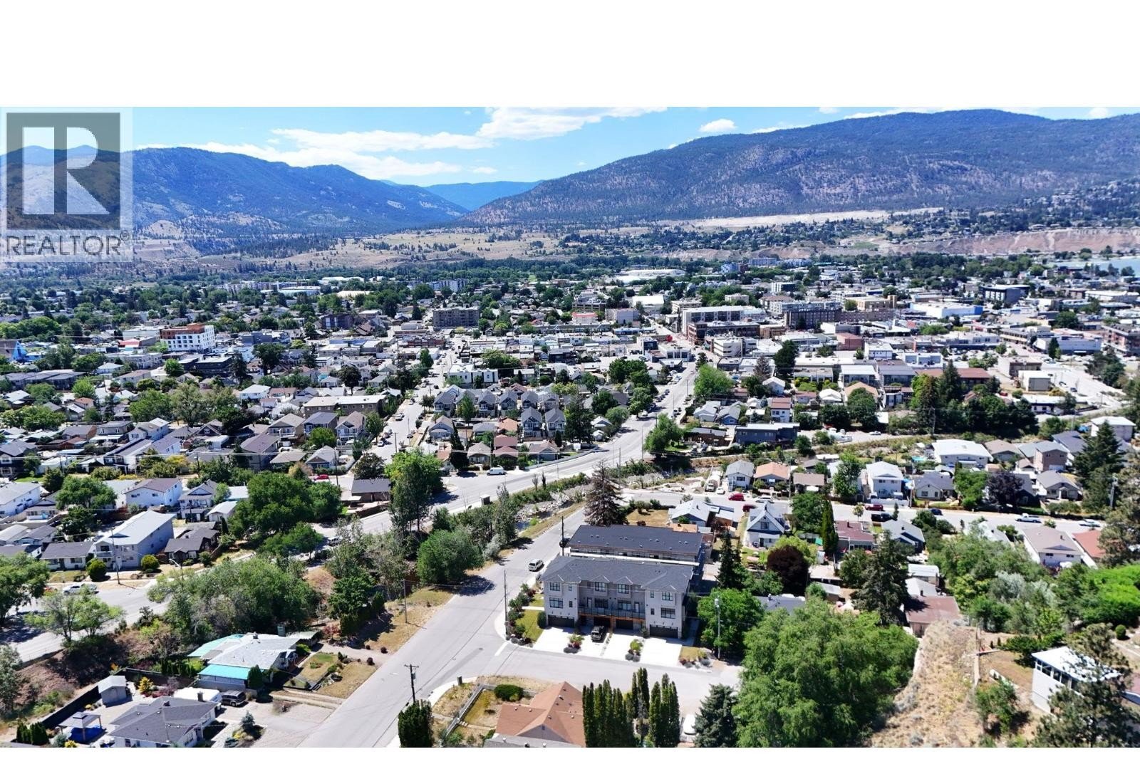 Unit 102 at The Wade Residences, 463 Wade Avenue, Penticton — aerial neighbourhood and construction view