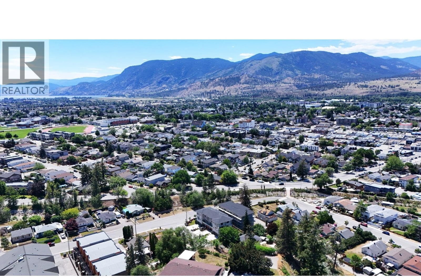 Unit 102 at The Wade Residences, 463 Wade Avenue, Penticton — aerial neighbourhood and construction view