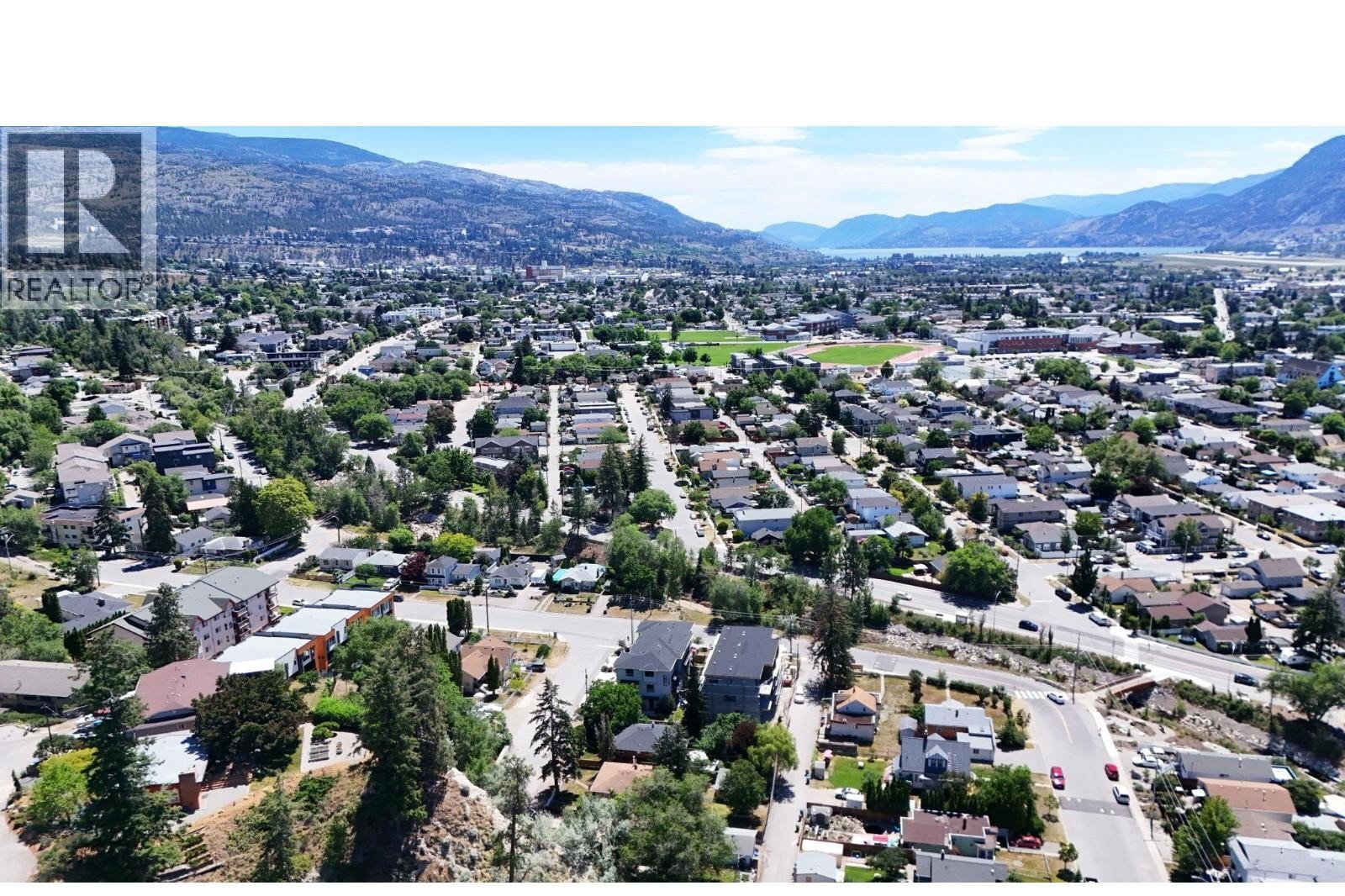 Unit 102 at The Wade Residences, 463 Wade Avenue, Penticton — aerial neighbourhood and construction view