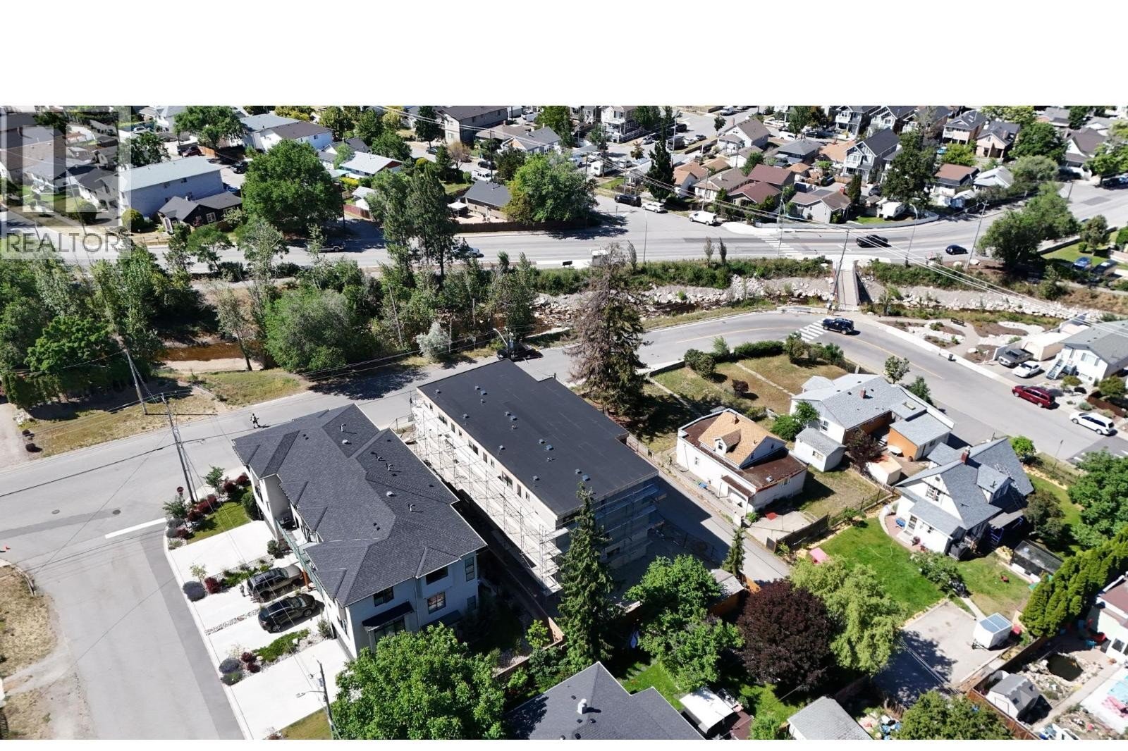 Unit 102 at The Wade Residences, 463 Wade Avenue, Penticton — aerial neighbourhood and construction view