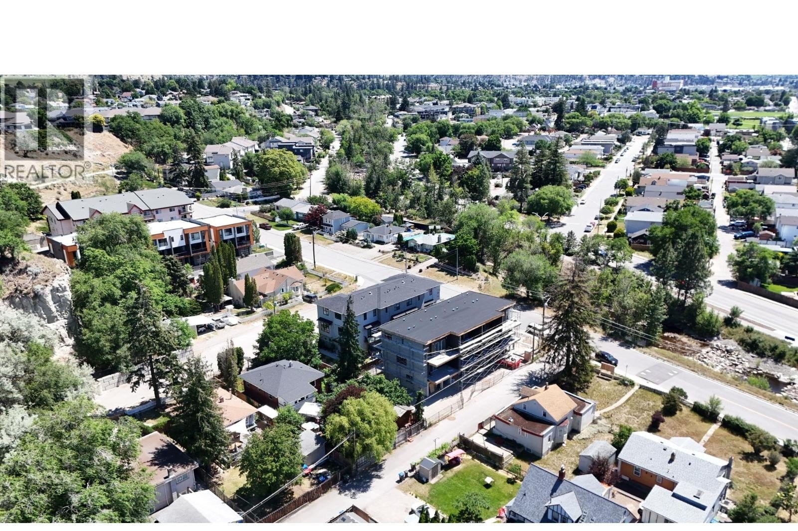Unit 102 at The Wade Residences, 463 Wade Avenue, Penticton — aerial neighbourhood and construction view