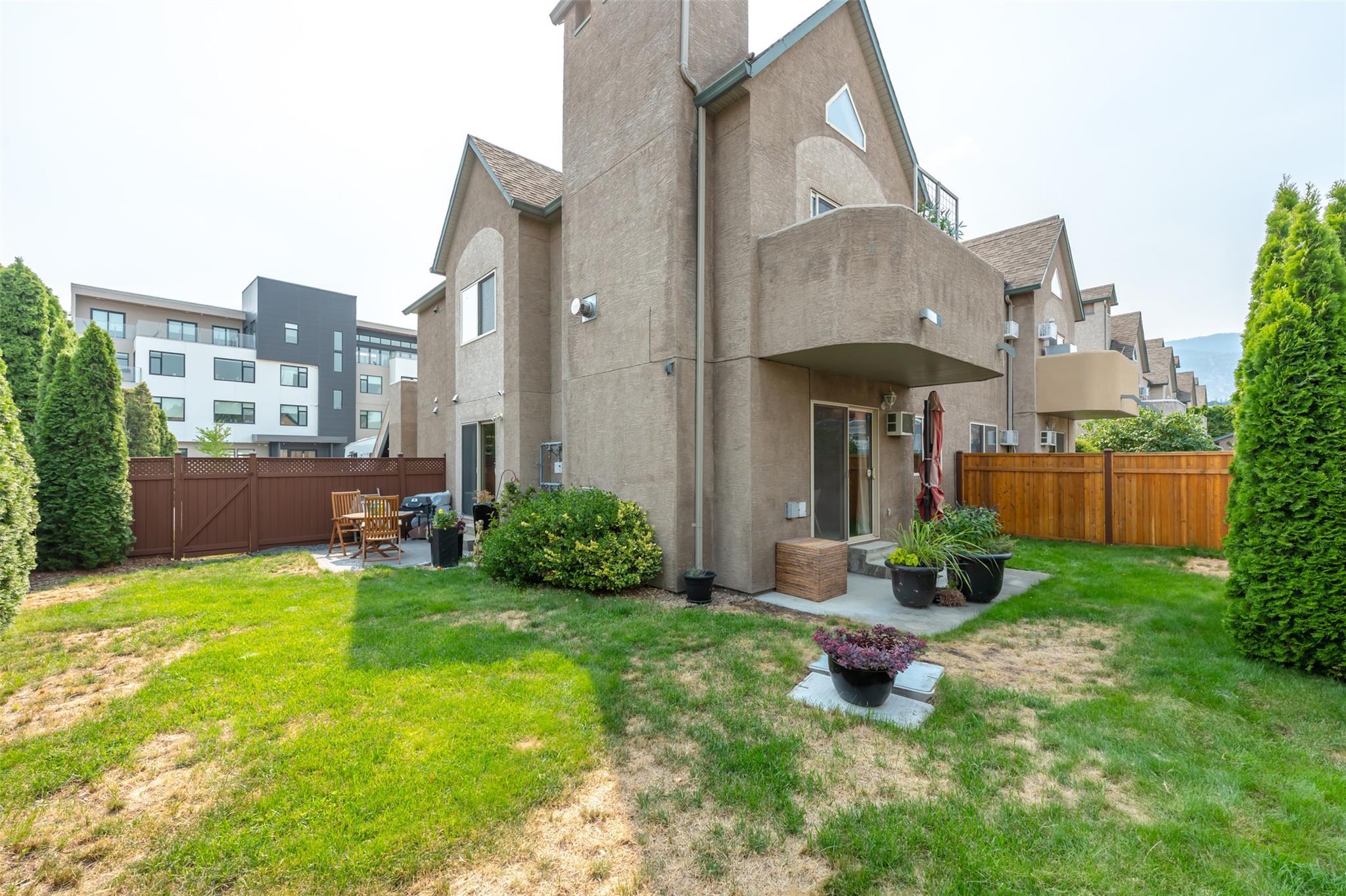 Rear exterior and private yard at Unit 101, 1049 Churchill Avenue.