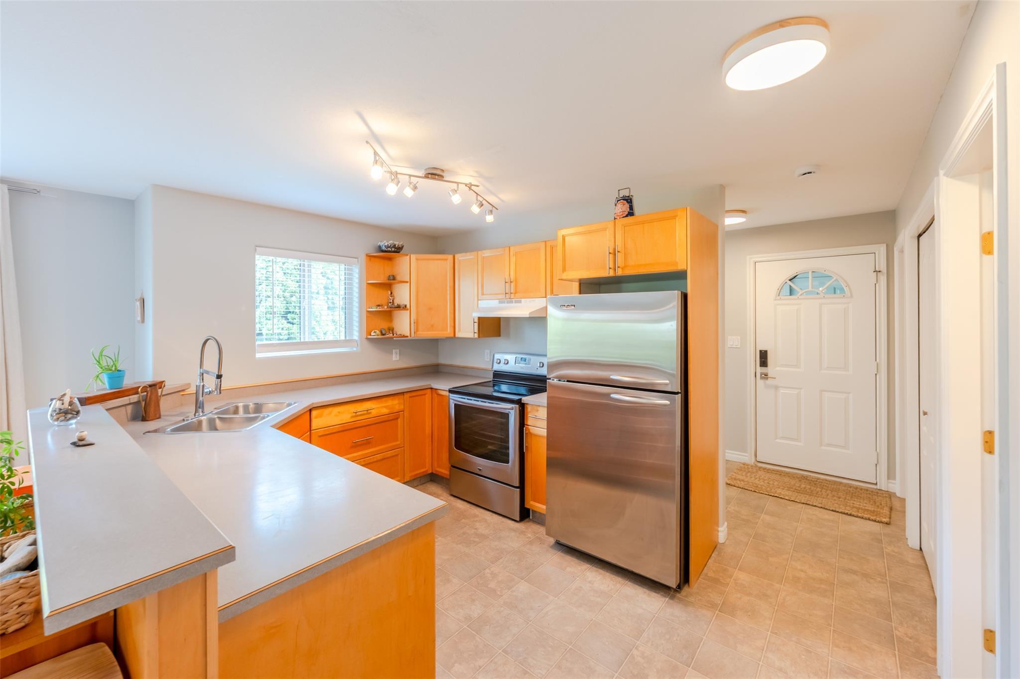Open kitchen with stainless-steel appliances in Unit 101.