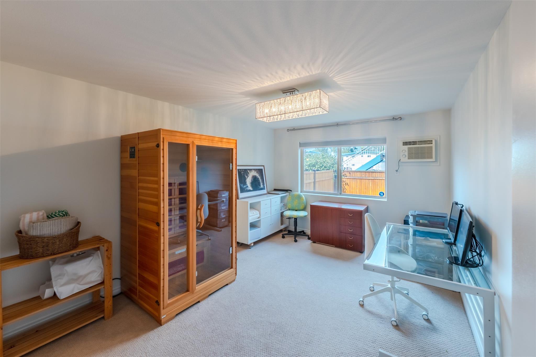 Second bedroom staged as a home office in Unit 101.