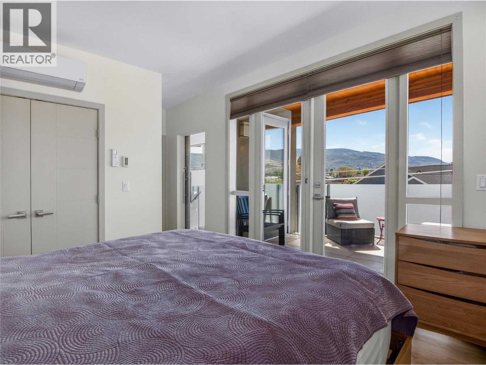 101-433 Churchill Avenue, Penticton — primary bedroom with rooftop-patio access and outlook