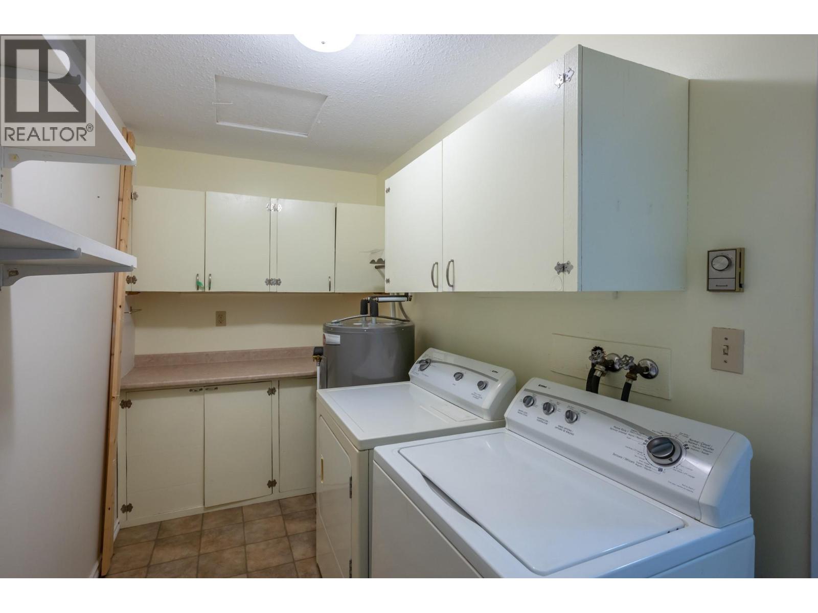 In-suite laundry and storage area in Unit 101 at 601 Wade Avenue W, Penticton