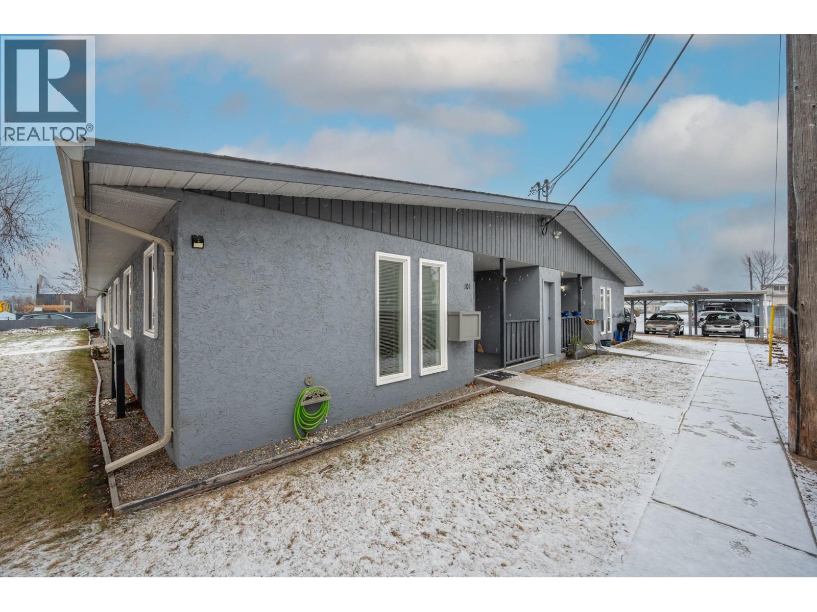 Side walkway and exterior context for Unit 101 at 601 Wade Avenue W, Penticton