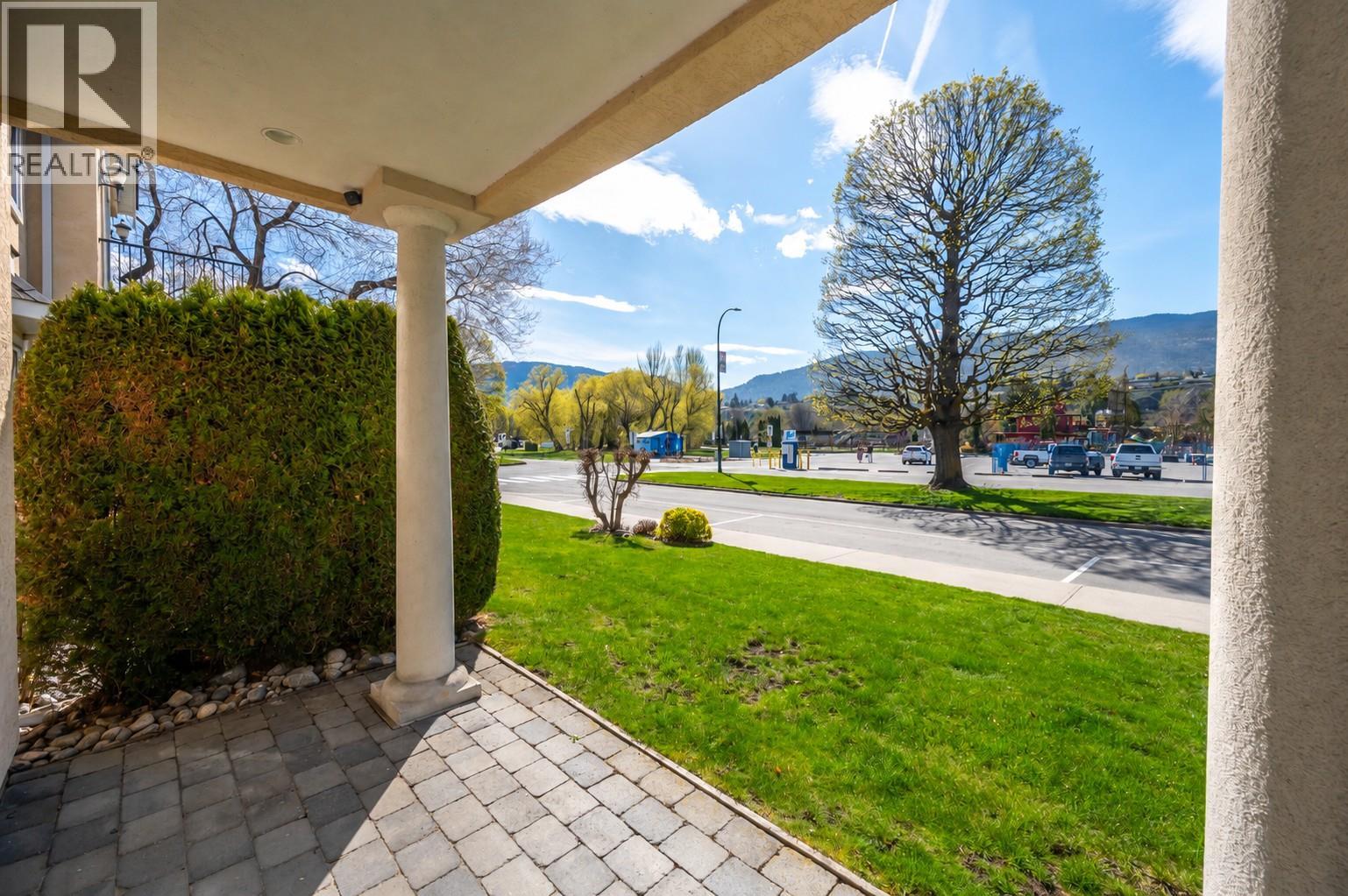 Covered entry patio and streetscape outlook at Unit 102.