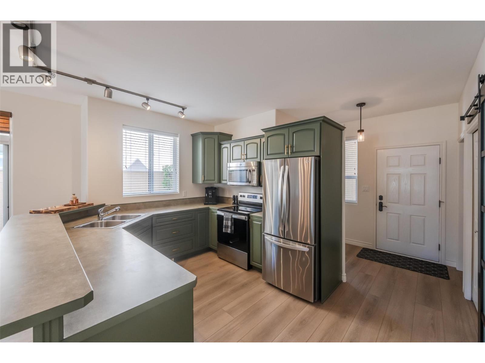 Updated kitchen with stainless appliances in Unit 102.