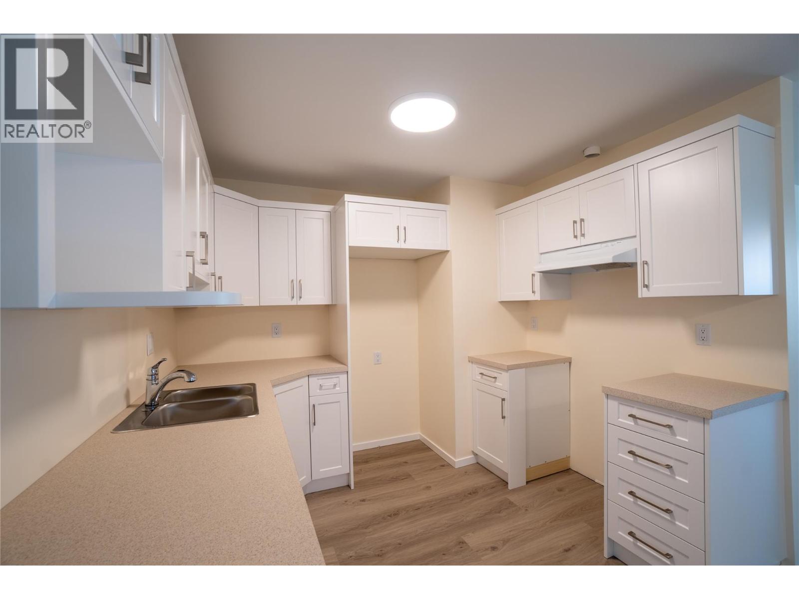 102 183 Maple Street, Penticton — renovated white kitchen