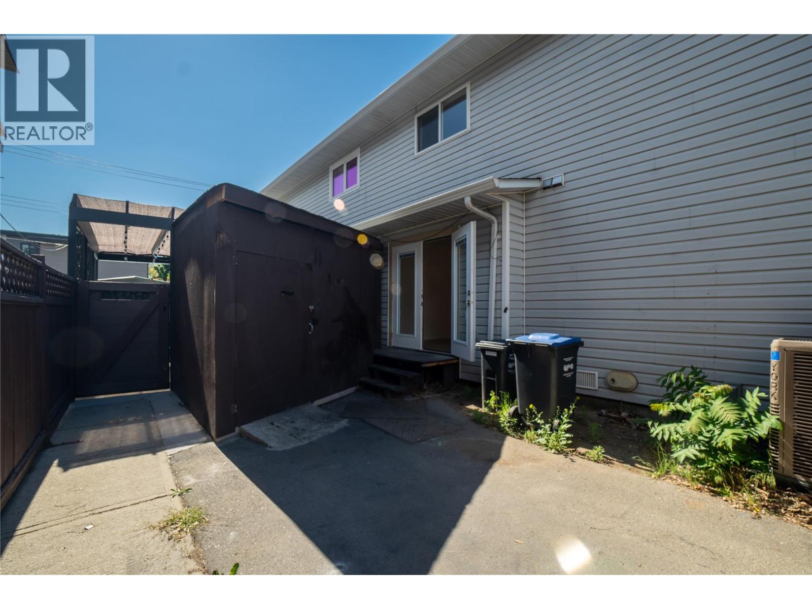 102 183 Maple Street, Penticton — fenced side patio and storage shed