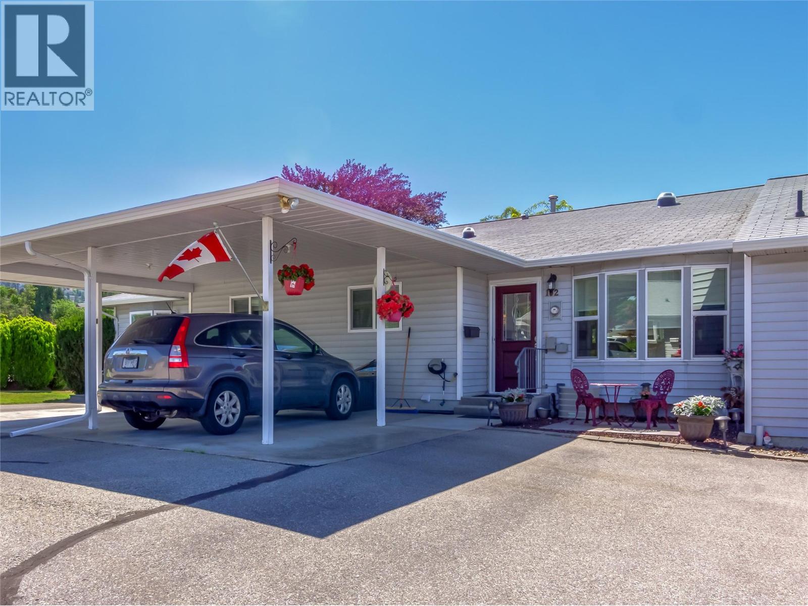 102-2445 South Main Street, Penticton — front exterior and covered parking