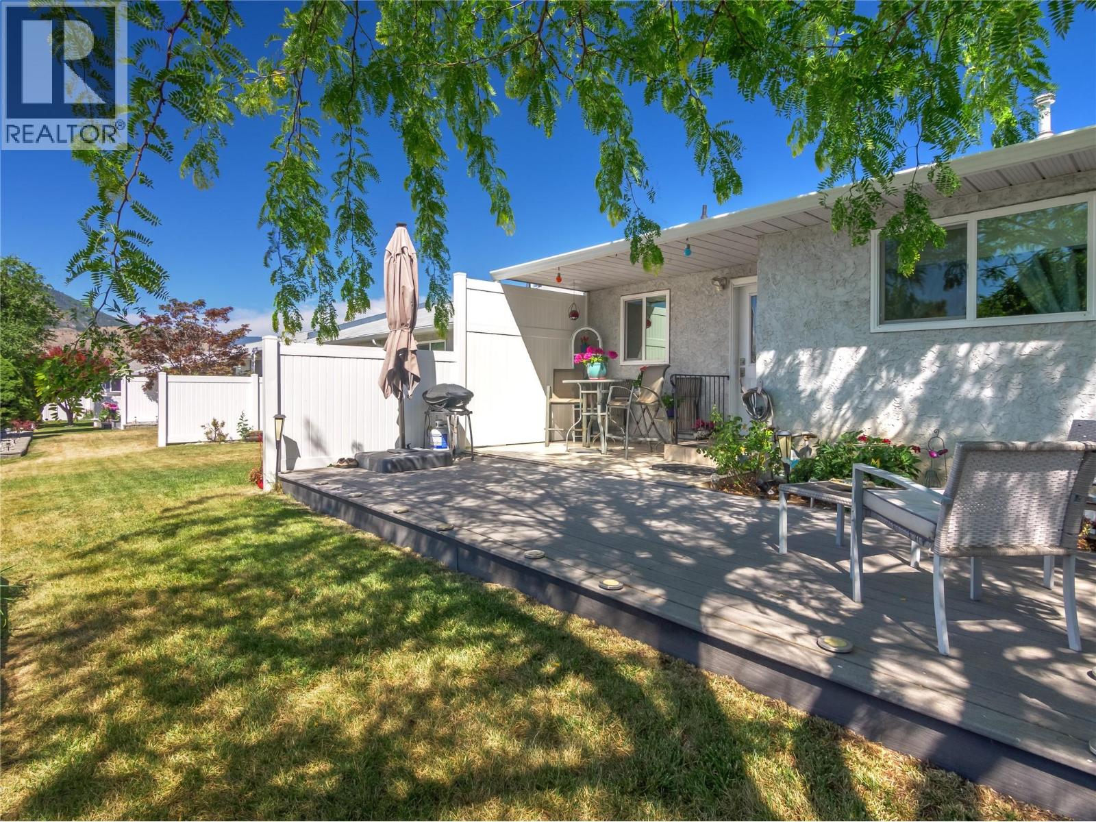102-2445 South Main Street, Penticton — private patio and lawn
