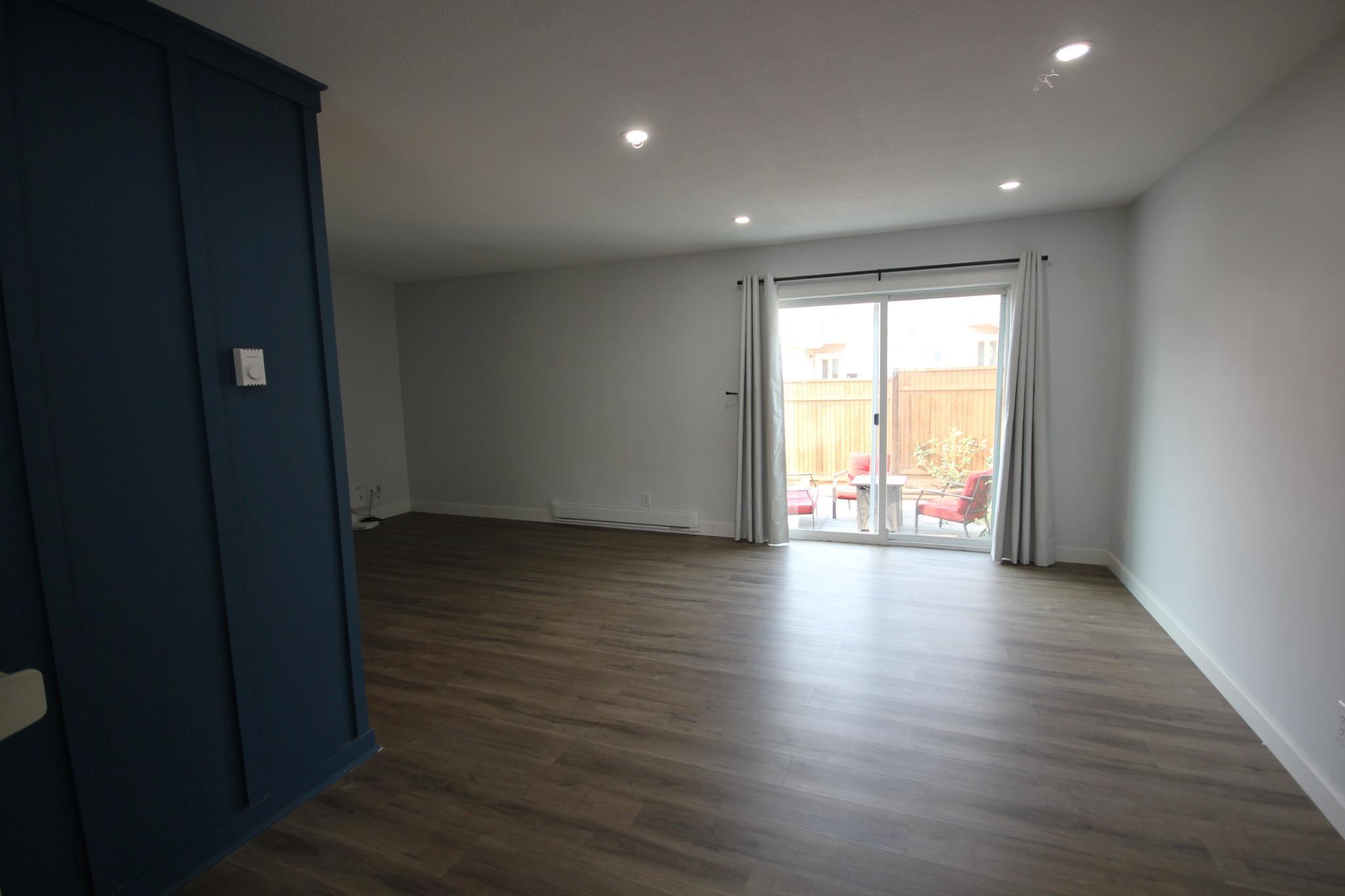 Open living and dining area with patio access in Unit 104.