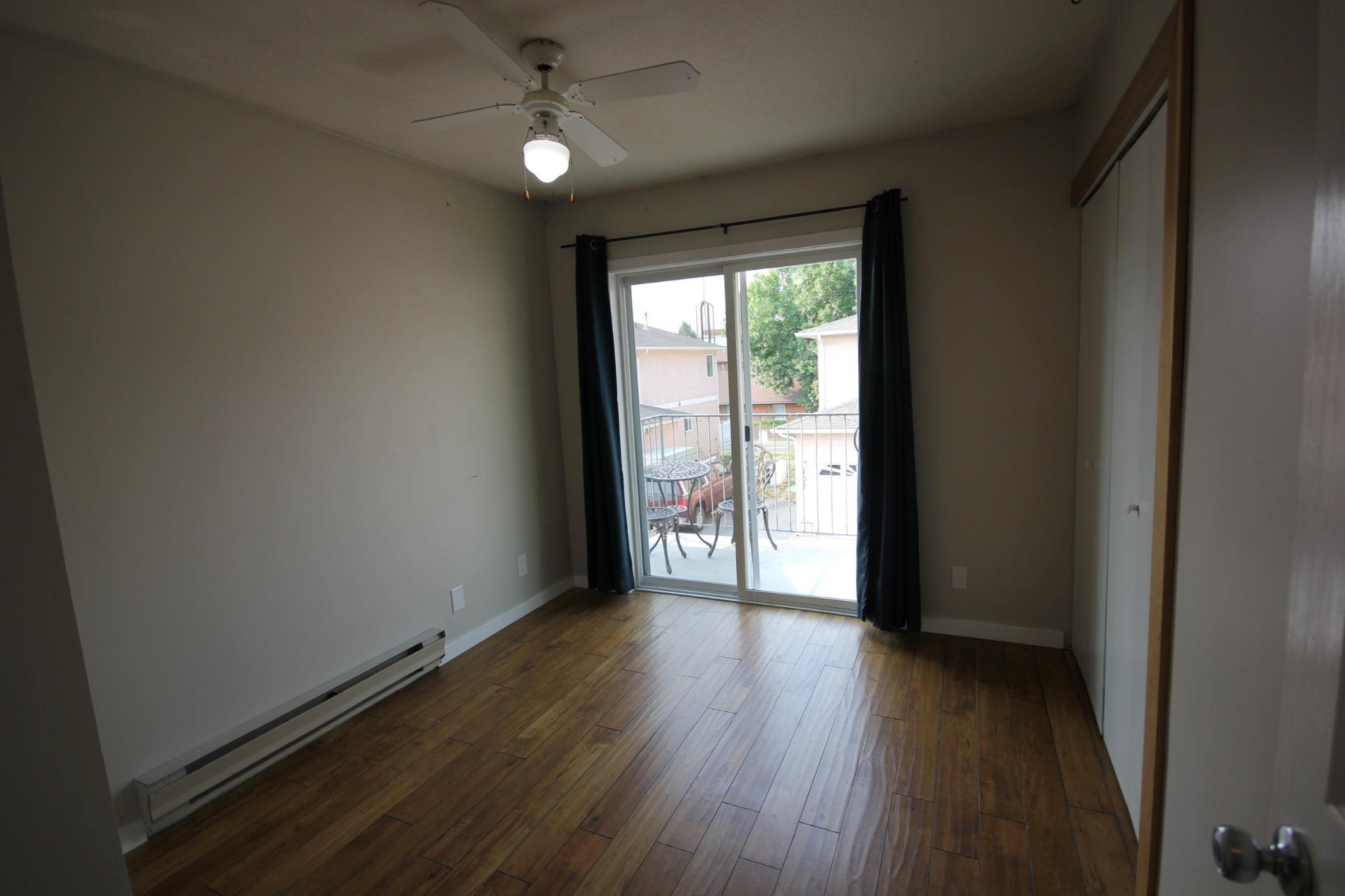 Bedroom with patio access in Unit 104.