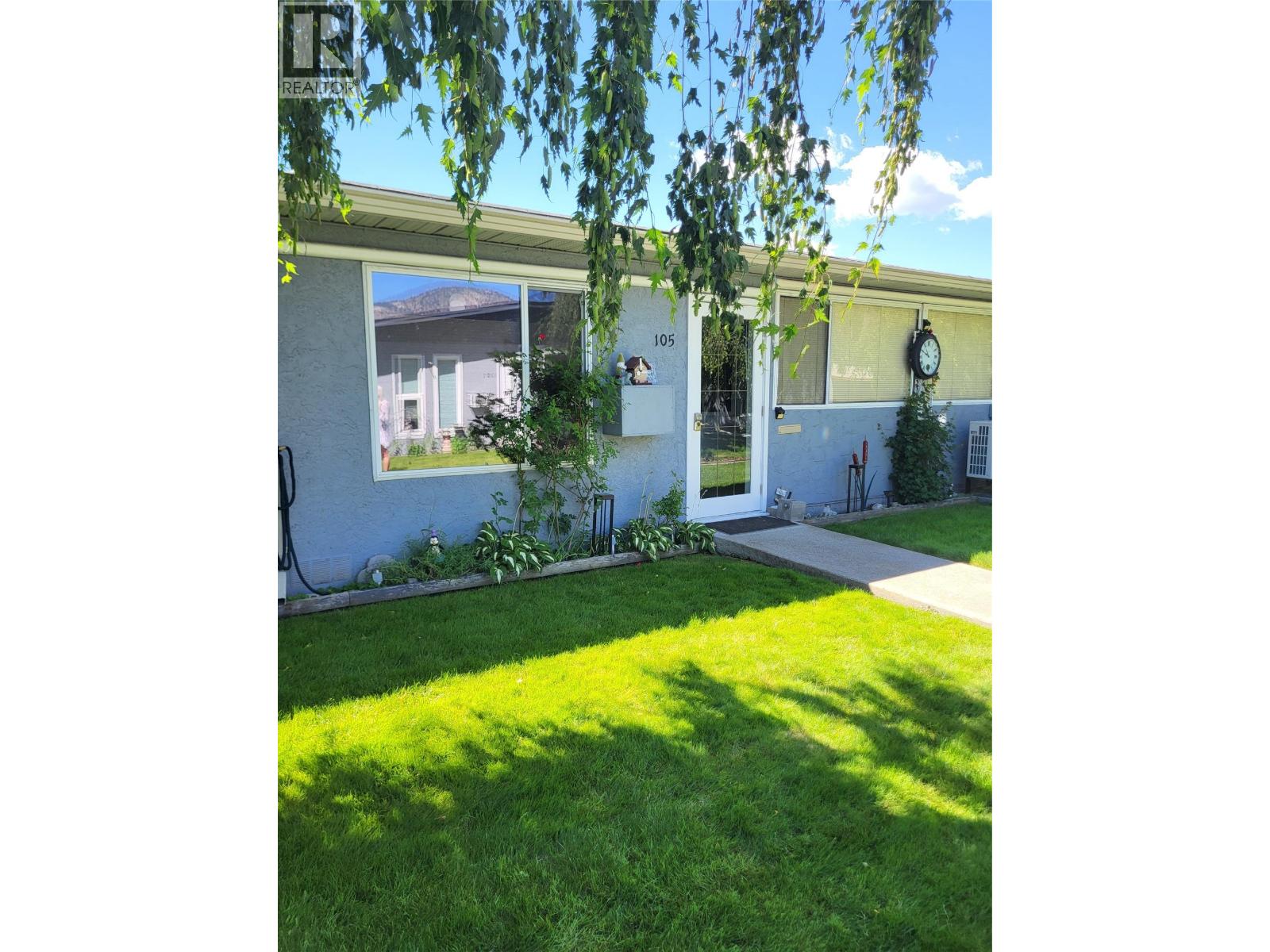 Front exterior and lawn at Unit 105, 601 Wade Avenue W, Penticton