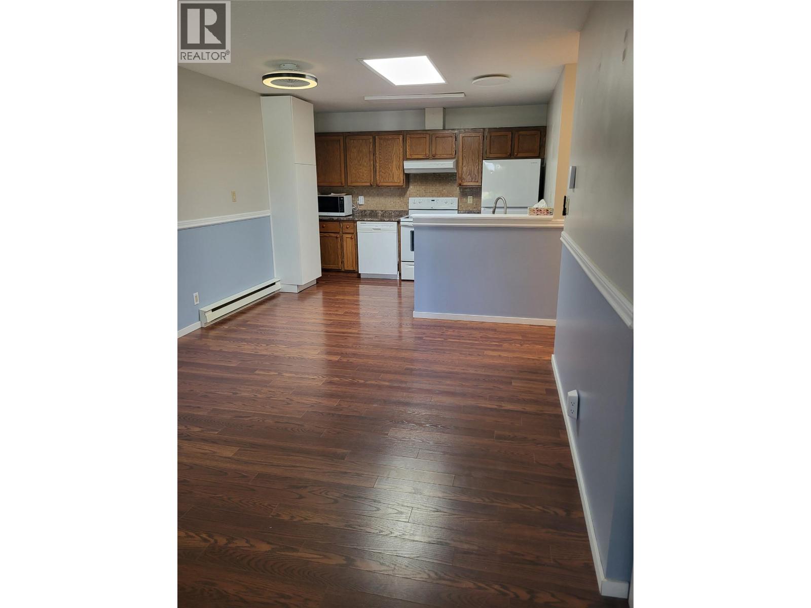 Open kitchen and living area in Unit 105 at 601 Wade Avenue W, Penticton