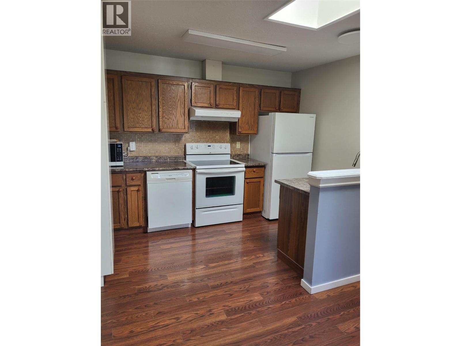 Kitchen cabinetry and appliances in Unit 105 at 601 Wade Avenue W, Penticton