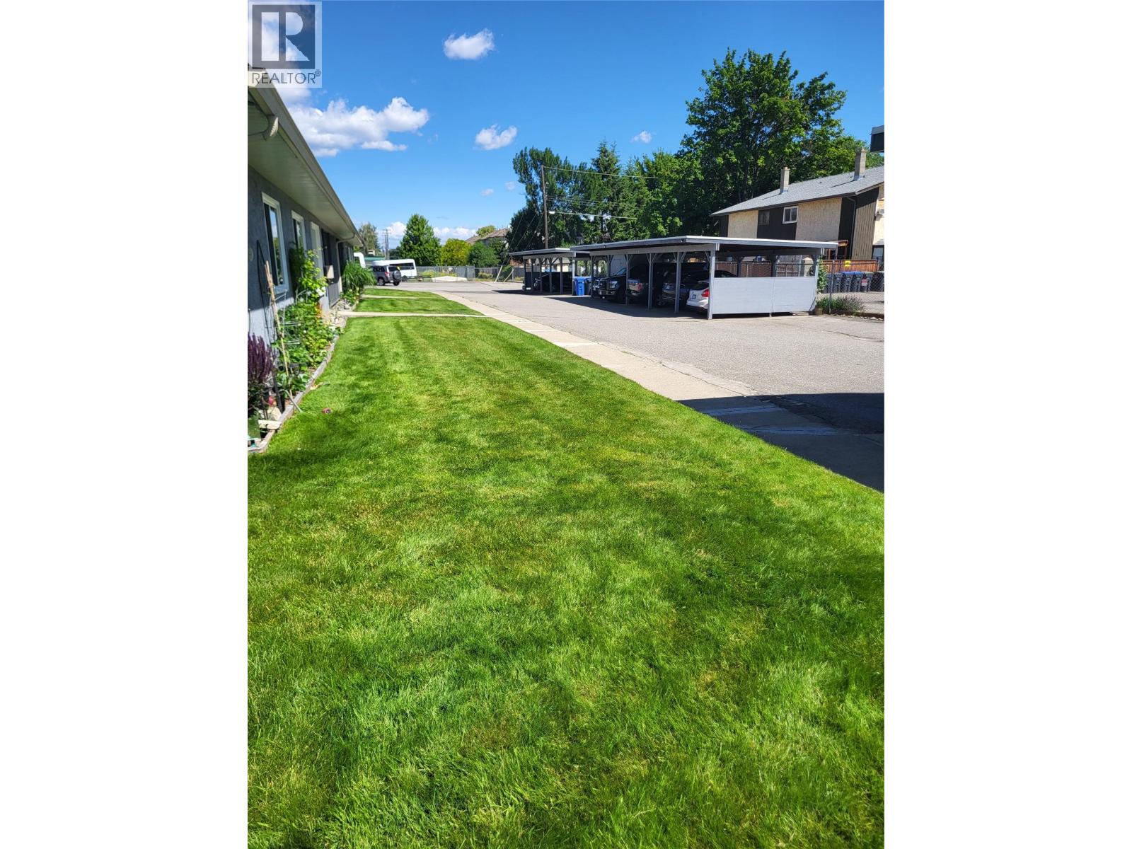 Shared lawn and covered parking at 601 Wade Avenue W Townhomes, Penticton
