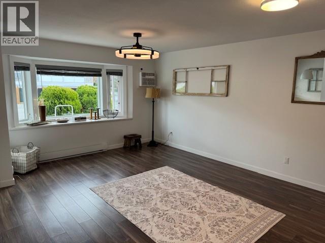 Bright living room with bay window in Unit 108 at 3065 Wilson Street.