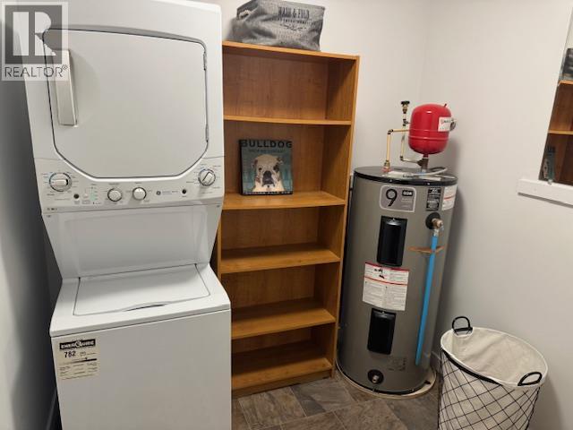 In-unit stacked laundry and utility storage in Unit 108.