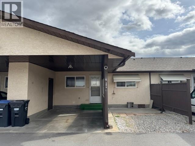 Covered rear carport and parking area for Unit 108.