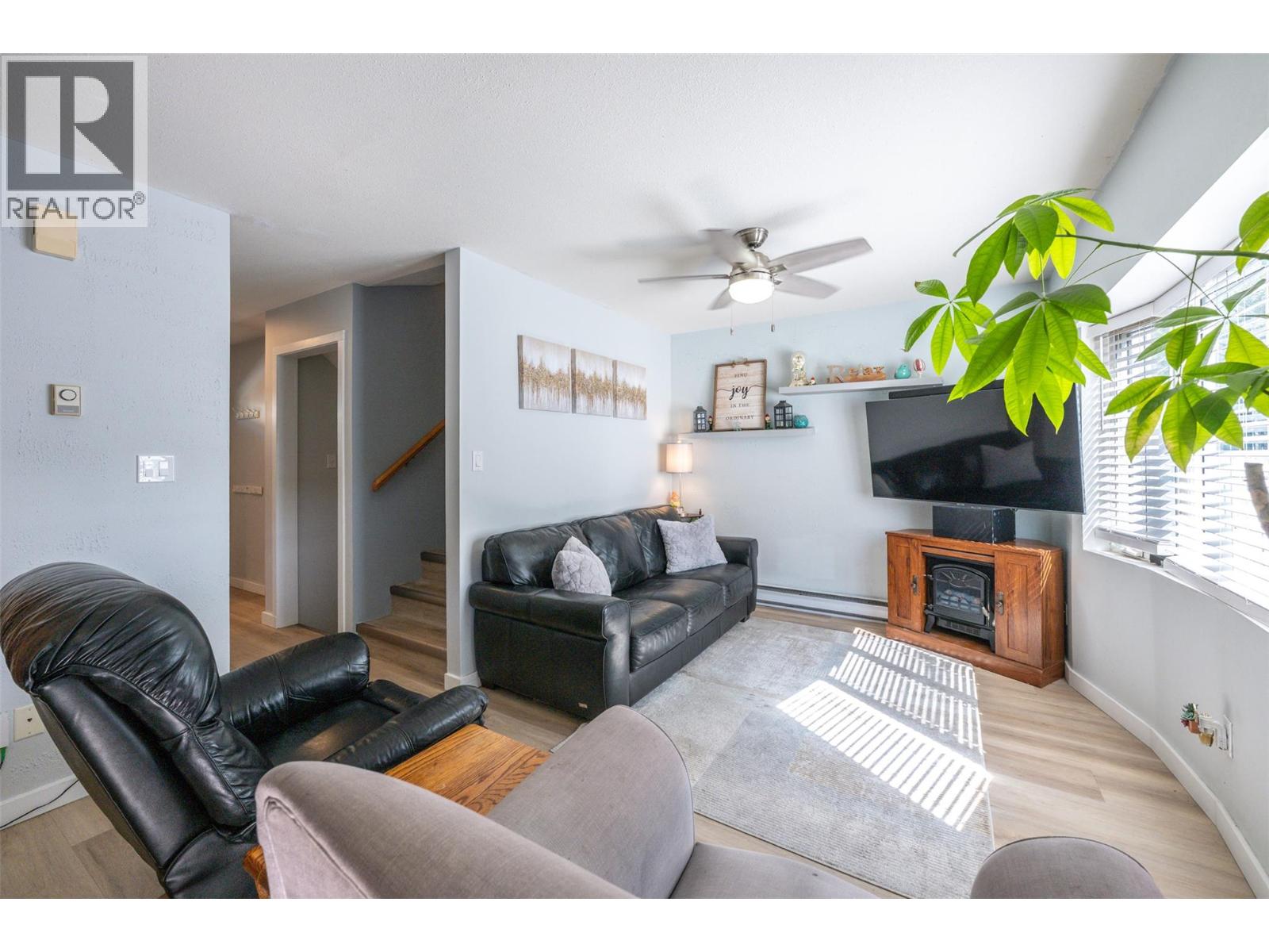 108 3372 South Main Street, Penticton — bright living room with fireplace