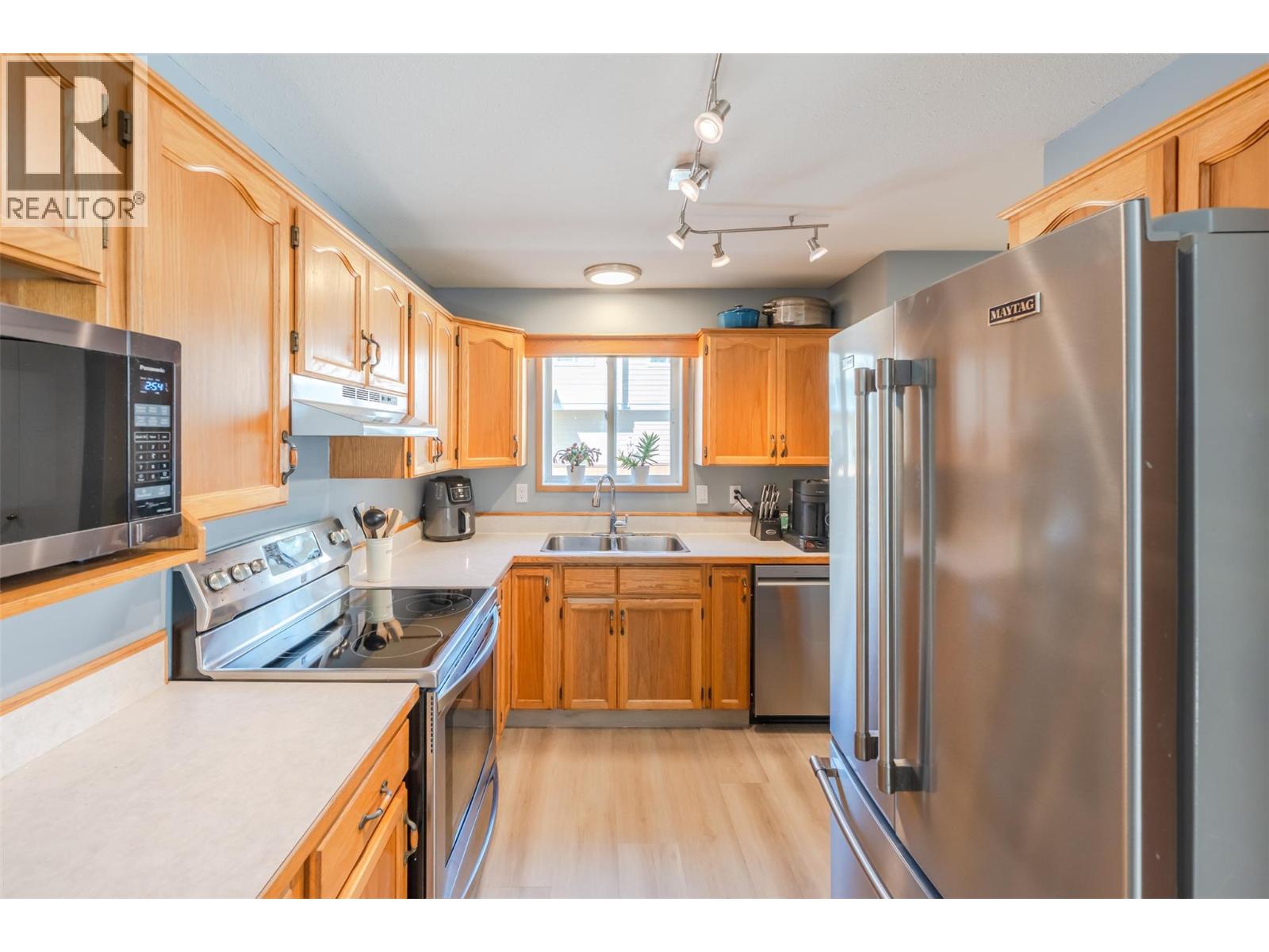108 3372 South Main Street, Penticton — wood kitchen with stainless appliances