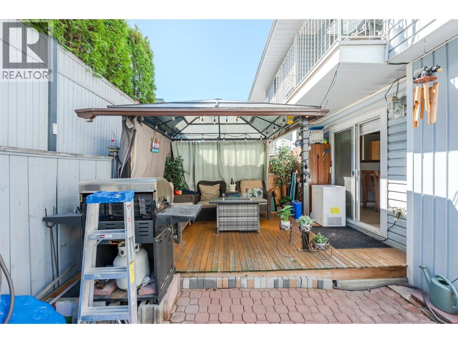 108 3372 South Main Street, Penticton — fenced outdoor space with pergola
