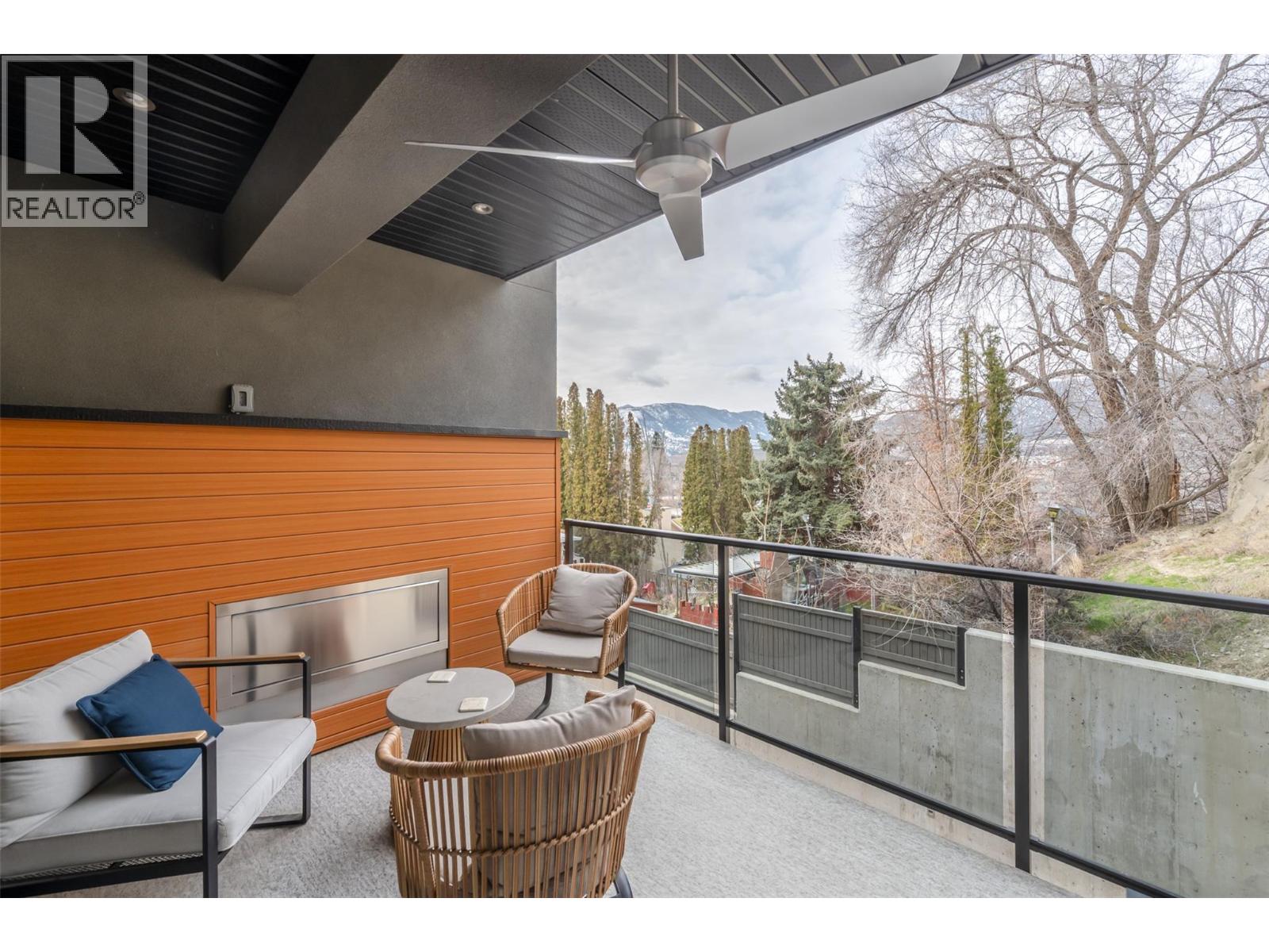 108 555 Wade Avenue E, Penticton — covered patio with gas fireplace