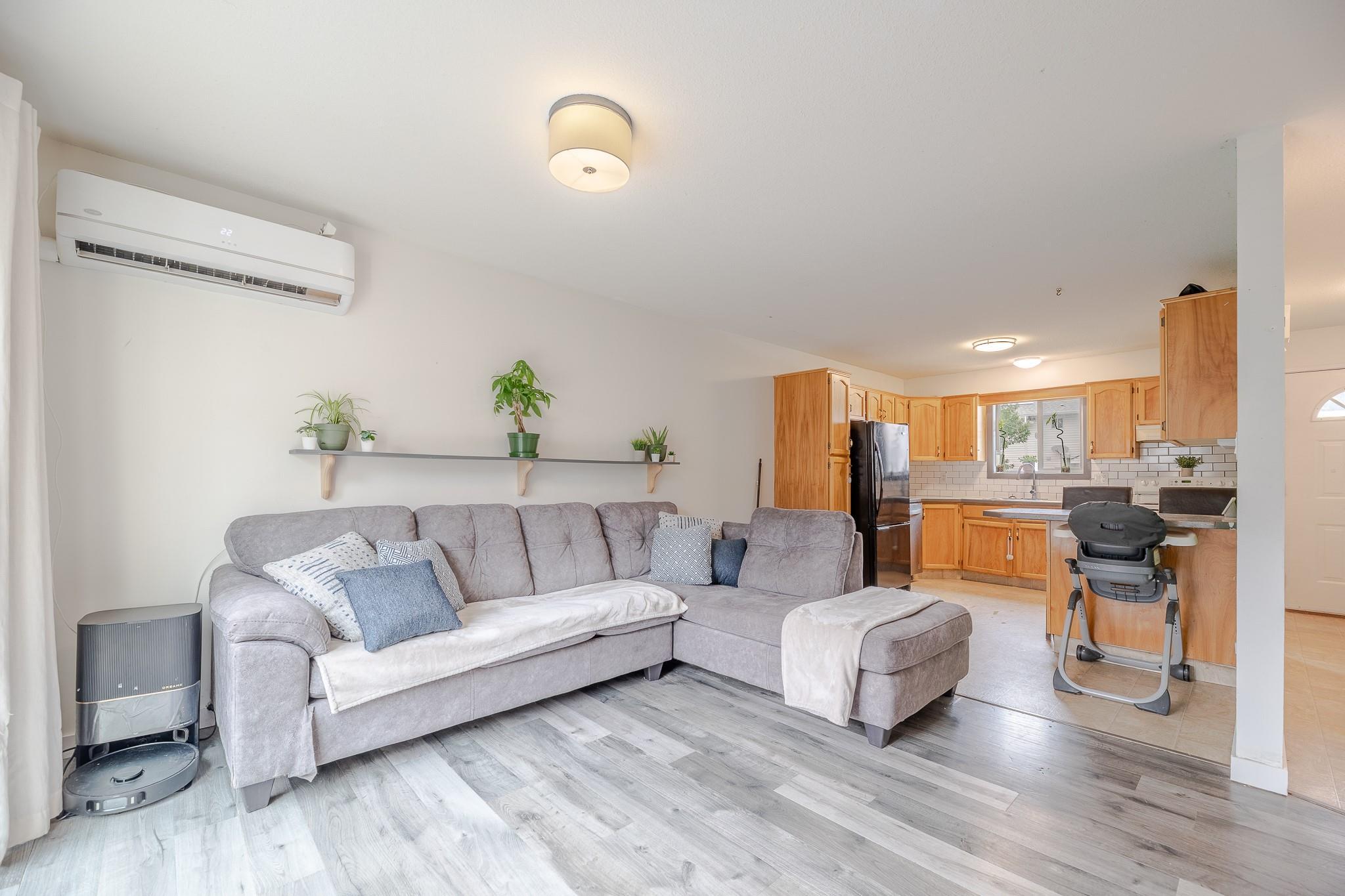 Bright open living room in Unit 124 at 3004 South Main Street.