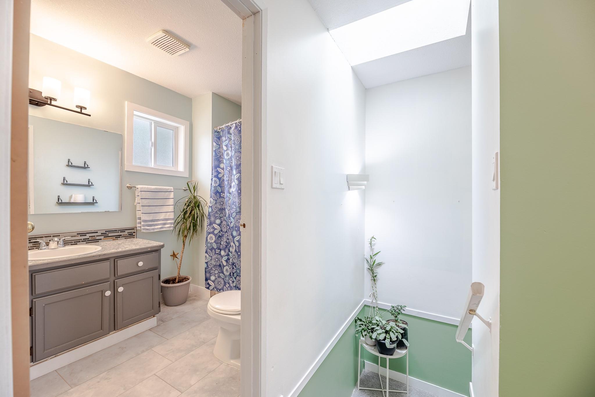 Updated full bathroom with tub and shower in Unit 124.