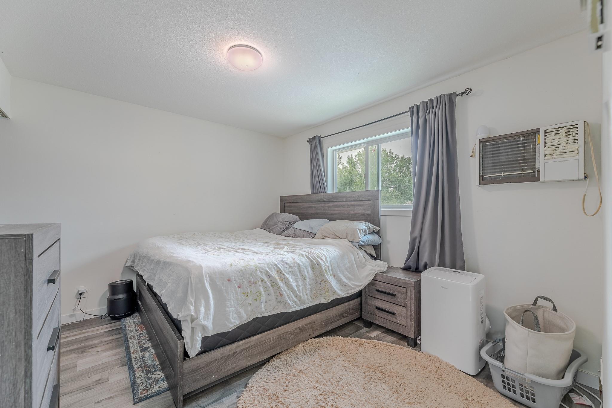 Primary bedroom with large window in Unit 124.