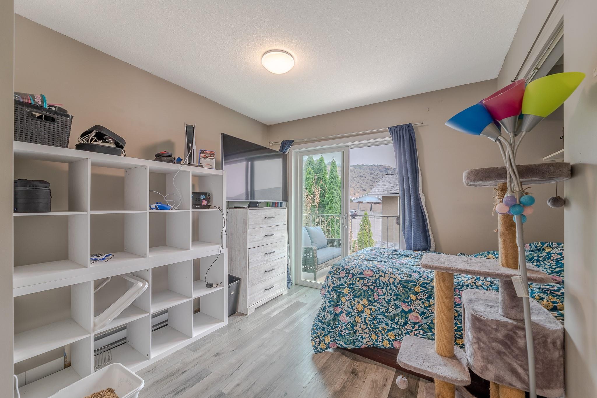 Second bedroom with balcony access in Unit 124.