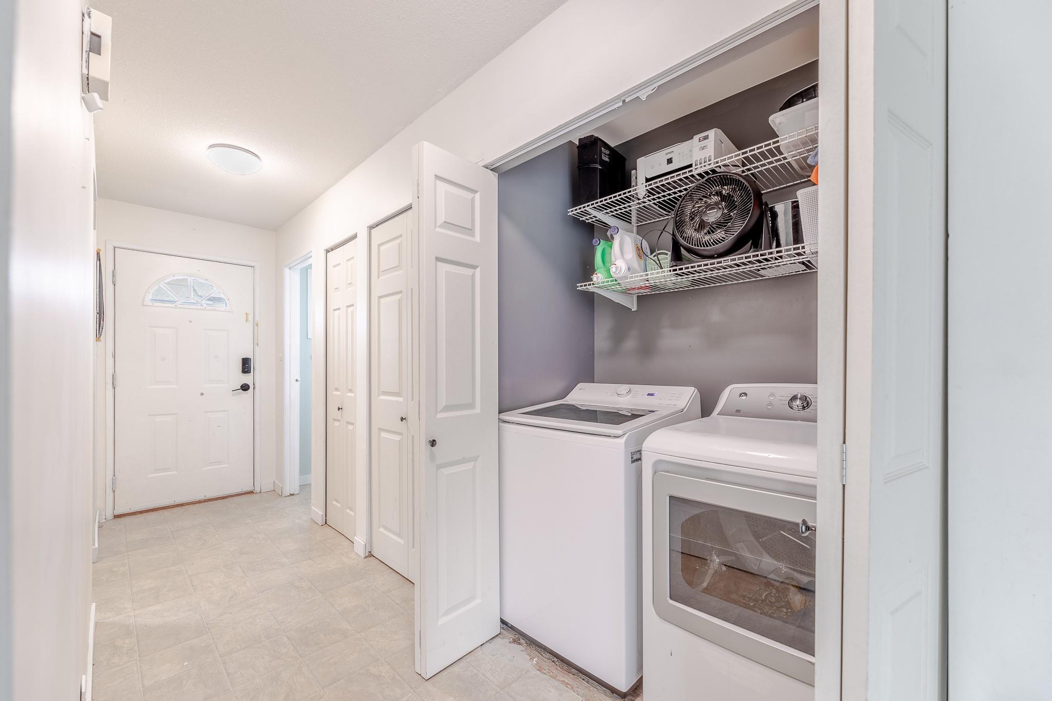 In-unit laundry area and storage at Unit 124.