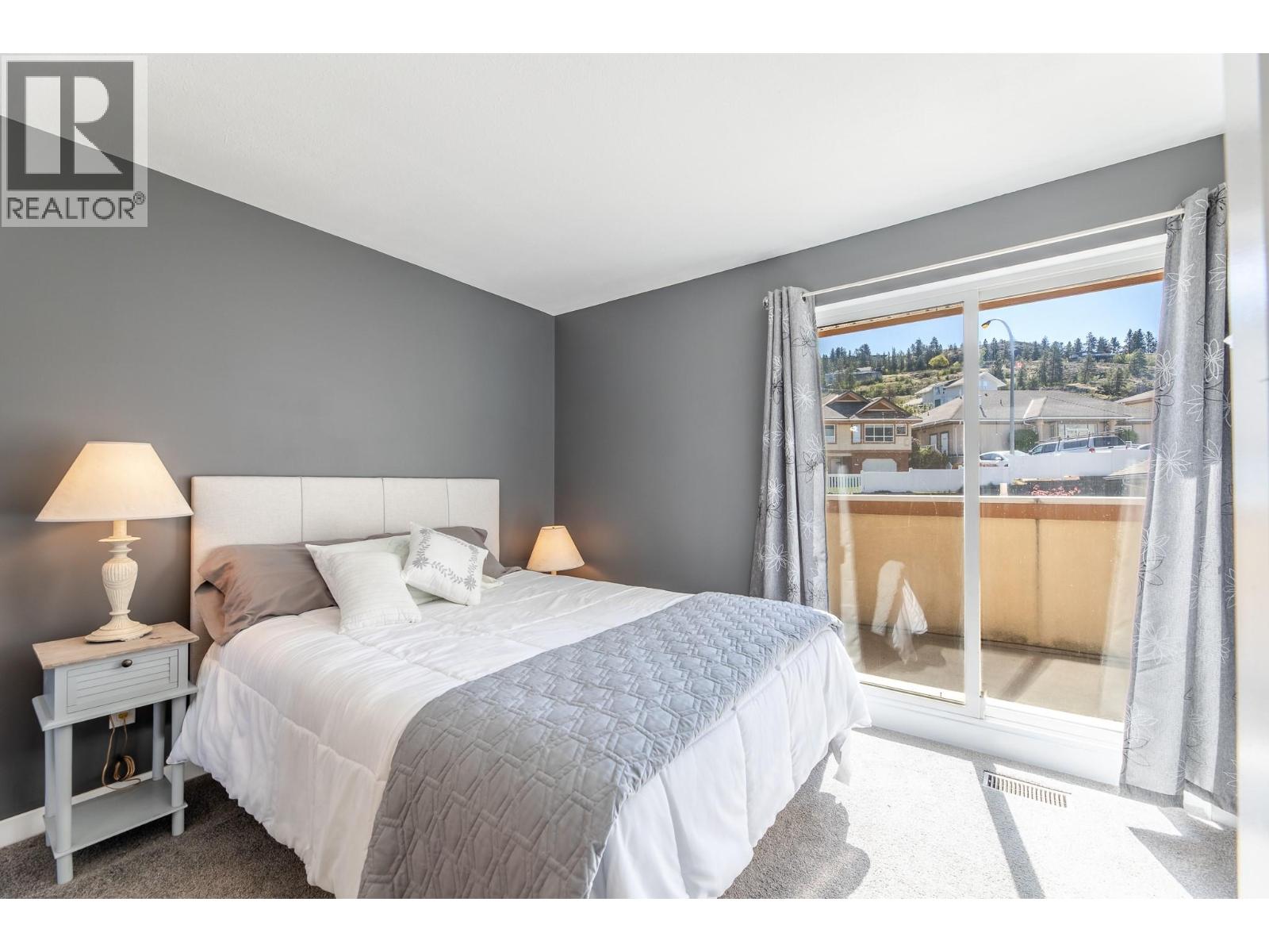 132 3948 Finnerty Road, Penticton — secondary bedroom with private balcony