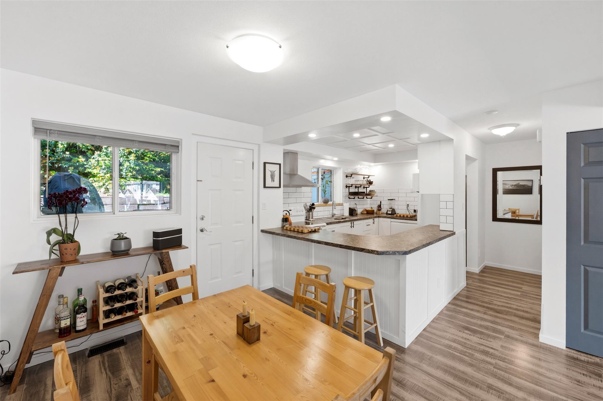 Dining area and open kitchen in Unit 189 at 1458 Penticton Avenue.